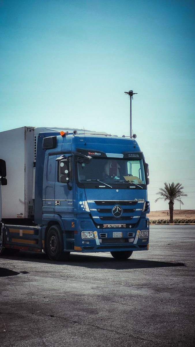 Refrigerated freight truck positioned near shipping containers